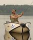 Man fishing alone in a small boat.