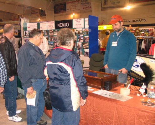 People at a trade show booth display.