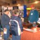 People at a trade show booth display.