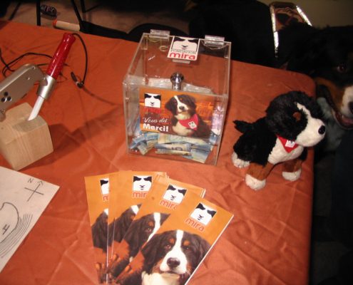 Donation box and dog-themed promotional items.