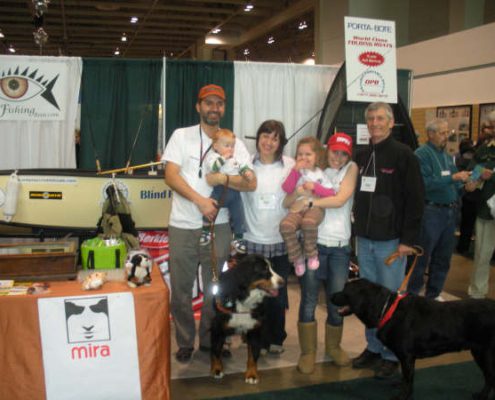 People and dogs at an indoor event.