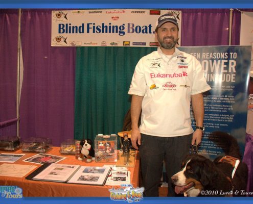 Man at Blind Fishing Boat booth display.