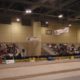 Indoor event with audience and empty stage.