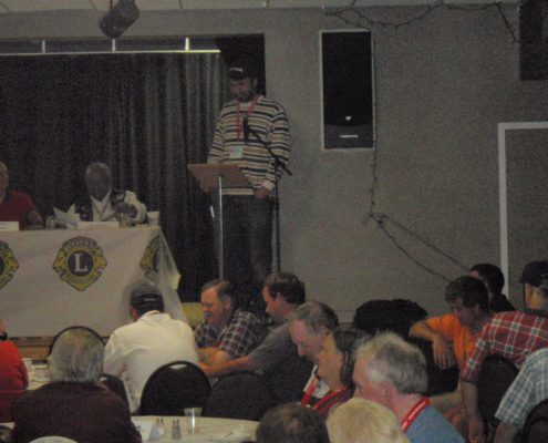 Man speaking at a Lions Club meeting.