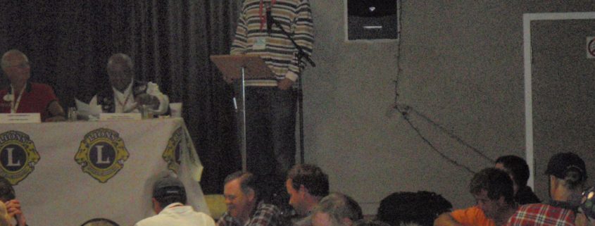 Man speaking at a Lions Club meeting.