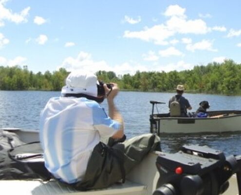 Bride and groom enjoying a lakeside wedding photo shoot.
