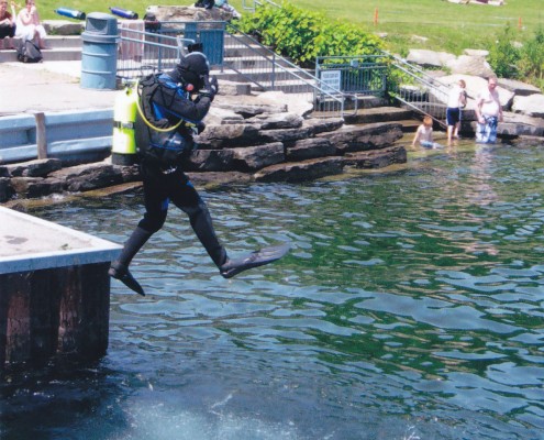 Person walking on water over a clear pond using stepping stones.