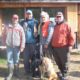 Four men standing outside with two dogs.