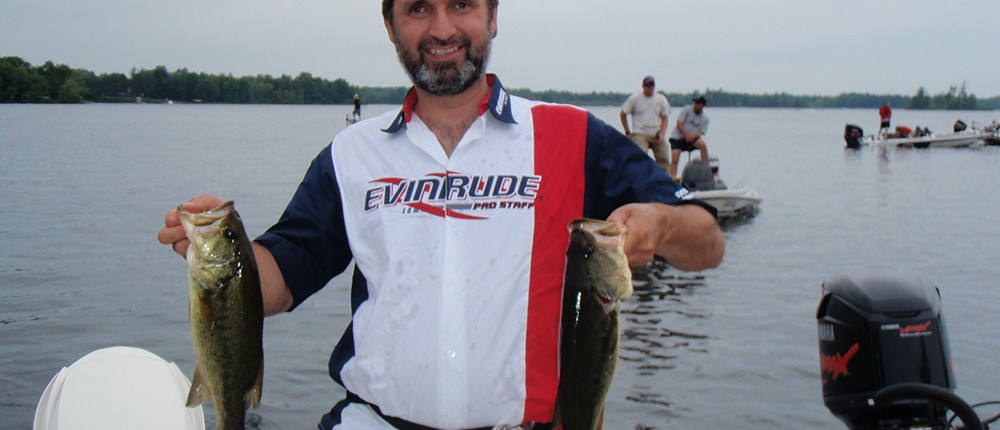 Lawrence holding 2 bass caught while fishing on White Lake