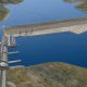 Aerial view of a long suspension bridge over water and land.