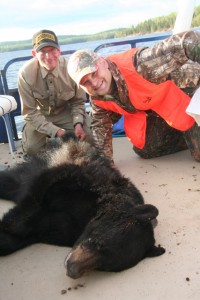 Hunters with their catch of a black bear
