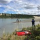 Lawrence and Dave Brown in Takhini River with huskies