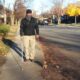 Person walking on a suburban street on a sunny autumn day.