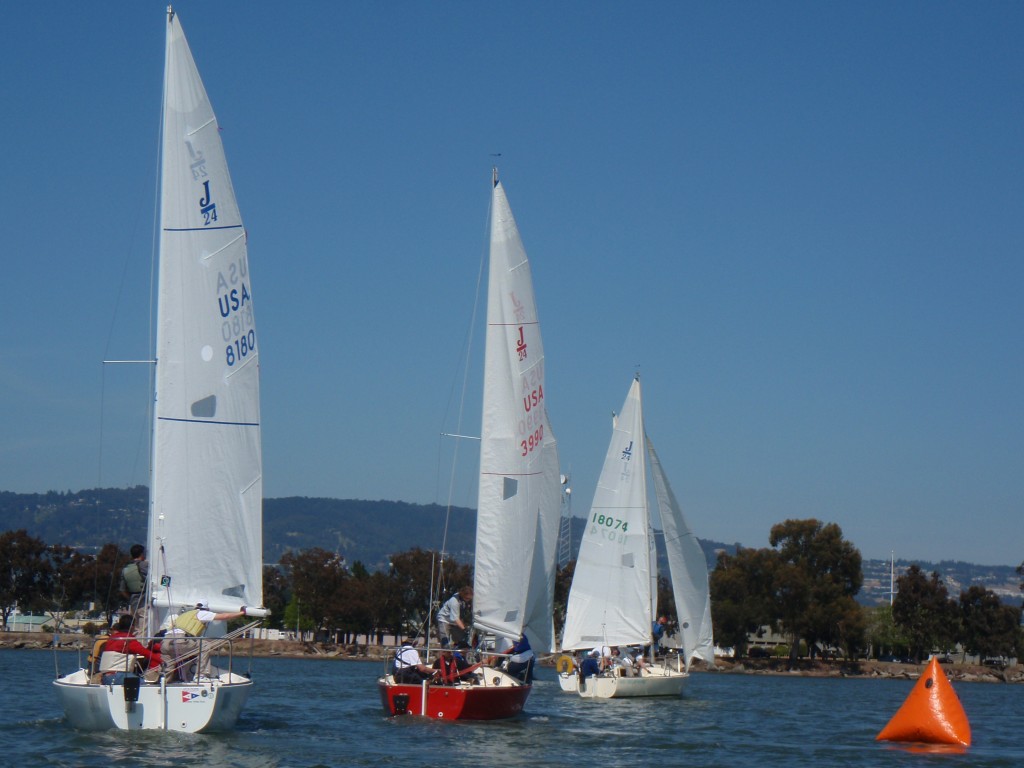 Sailboats racing on a sunny day with clear blue skies.
