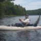 A man waterskiing behind a boat on a lake.