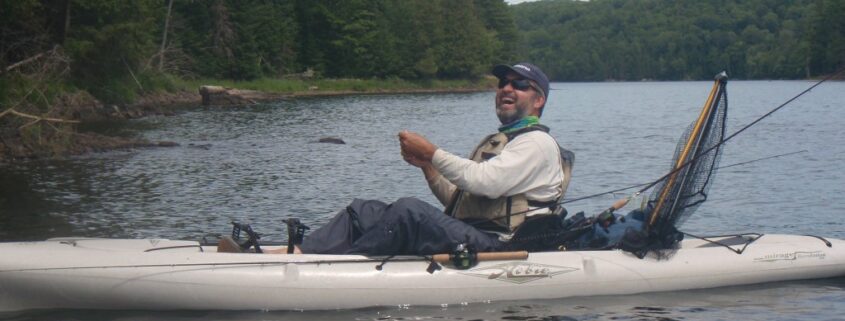 A man waterskiing behind a boat on a lake.