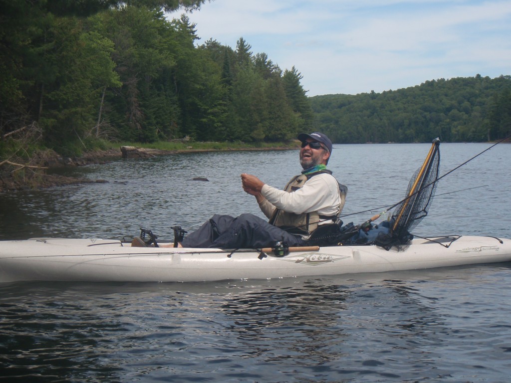 A man waterskiing behind a boat on a lake.