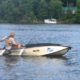 Man fishing on a small motorboat.