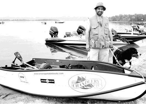Man with boat and dog on shore.